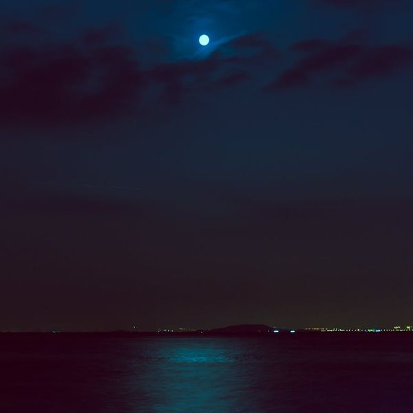 Serene natural landscape with a calm lake reflecting the sky.